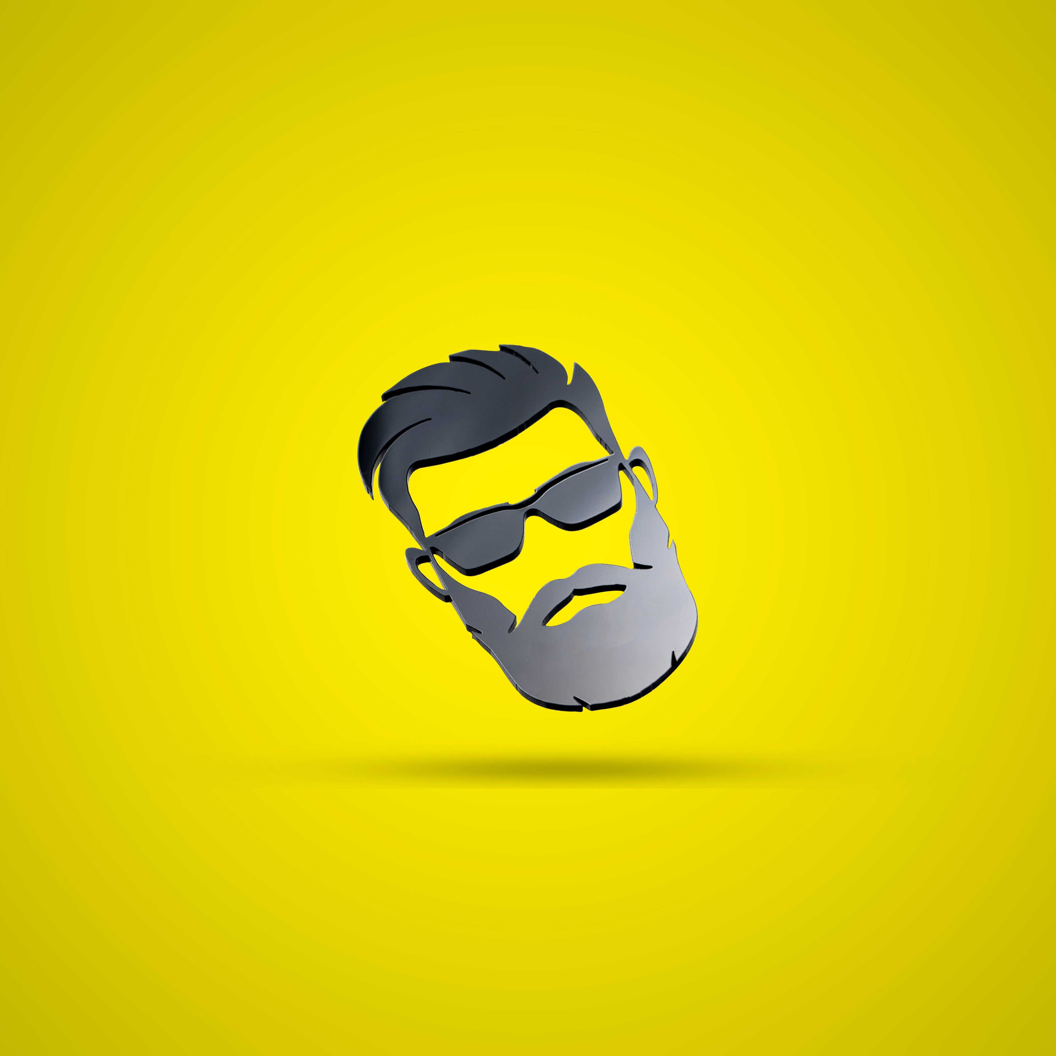 Bearded face with sunglasses on a yellow background