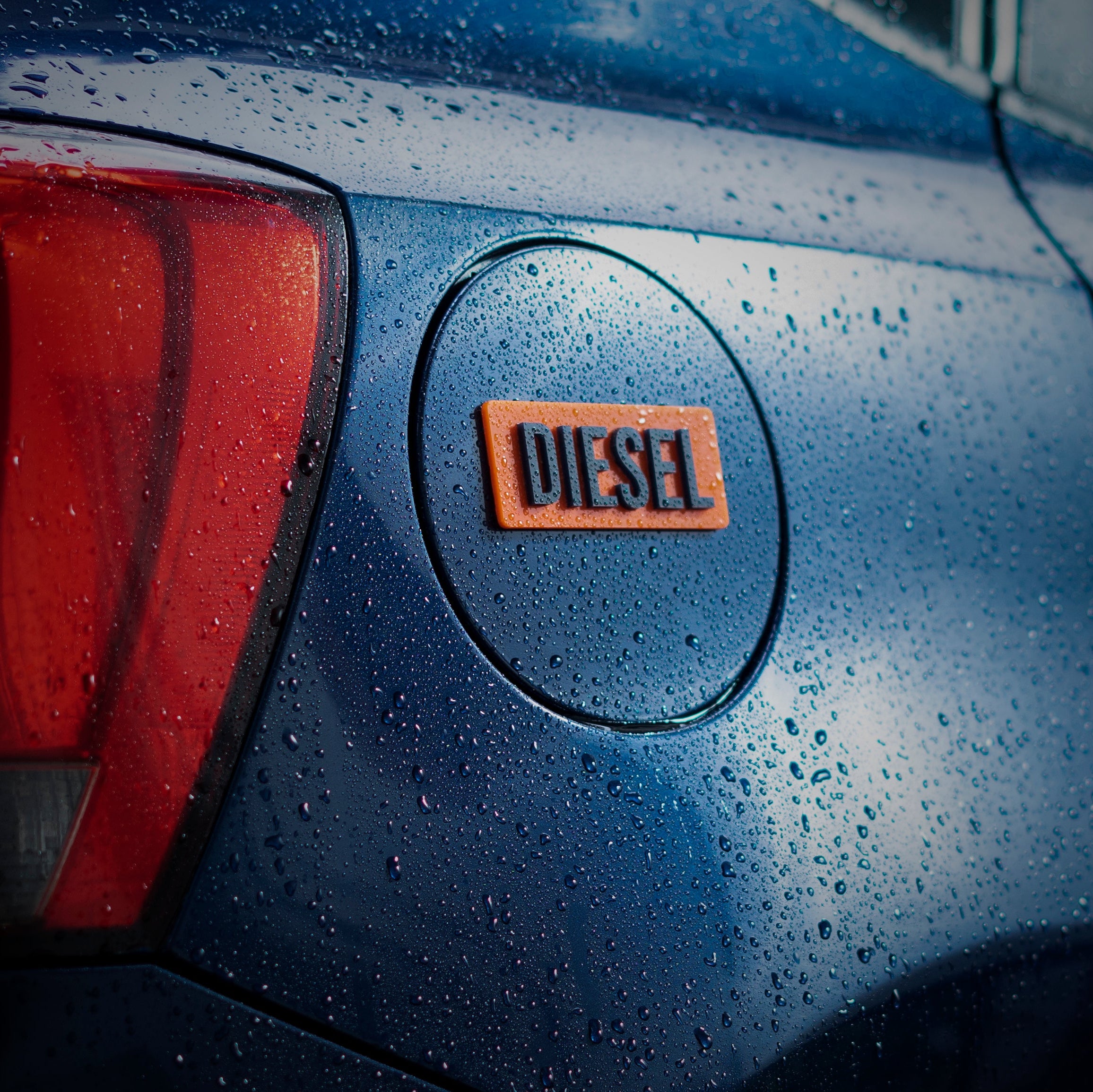 Close-up of a car with a 'DIESEL' logo on a wet surface