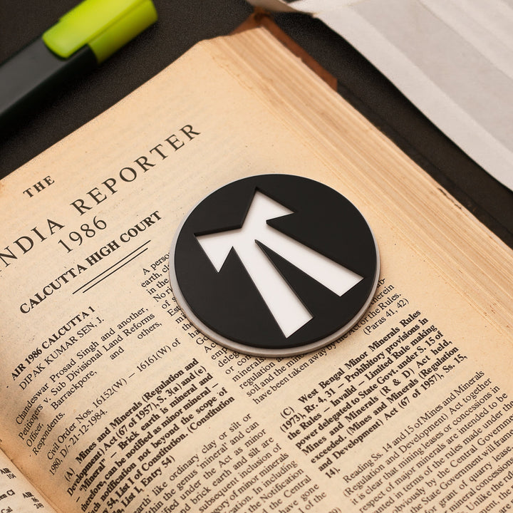 Black and white logo on a book with text