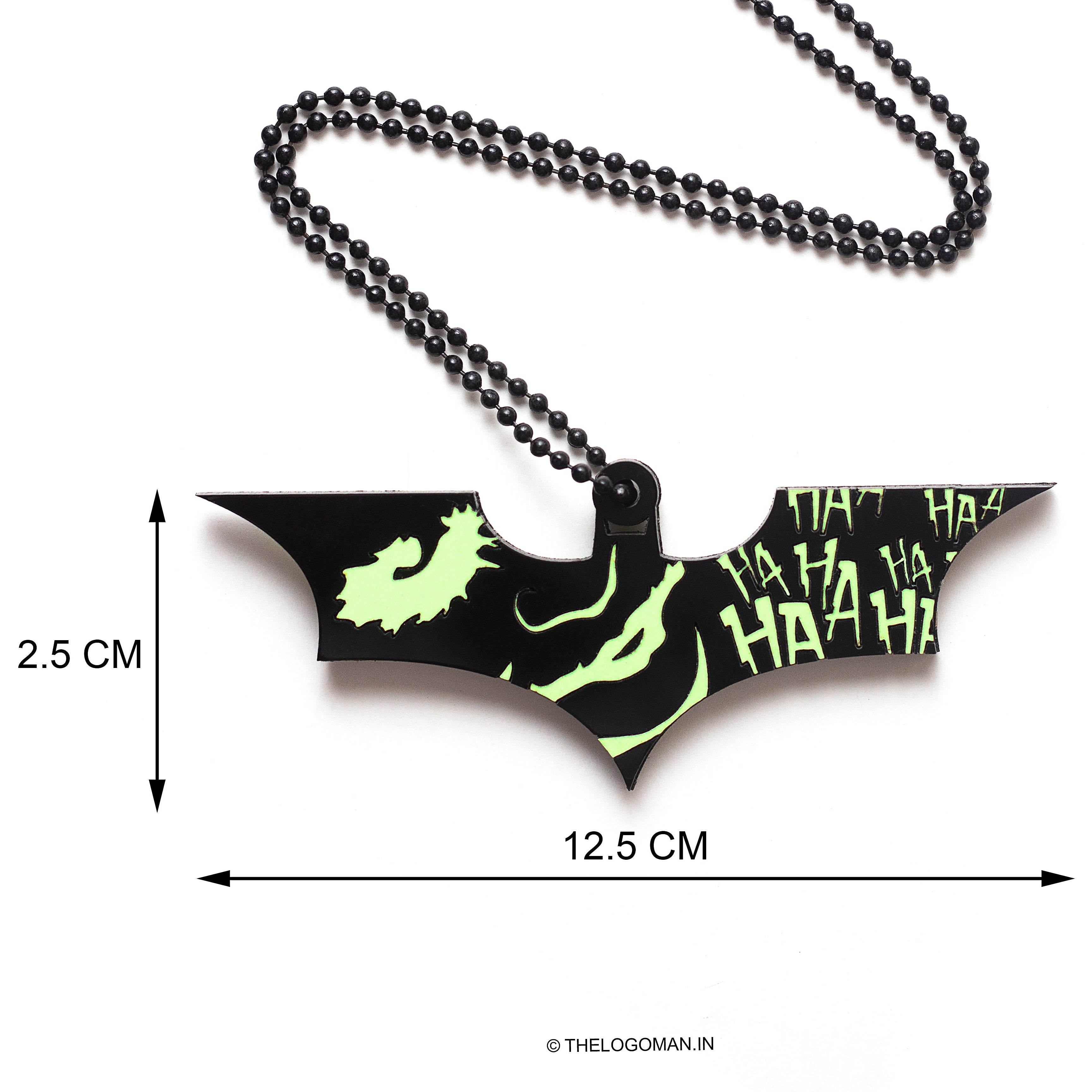 Bat-shaped pendant with measurements on a white background