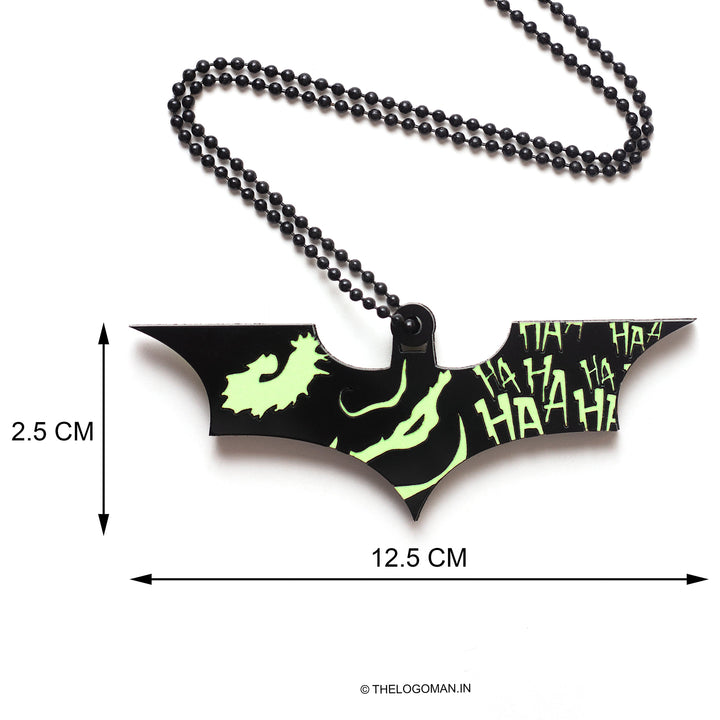 Bat-shaped pendant with measurements on a white background