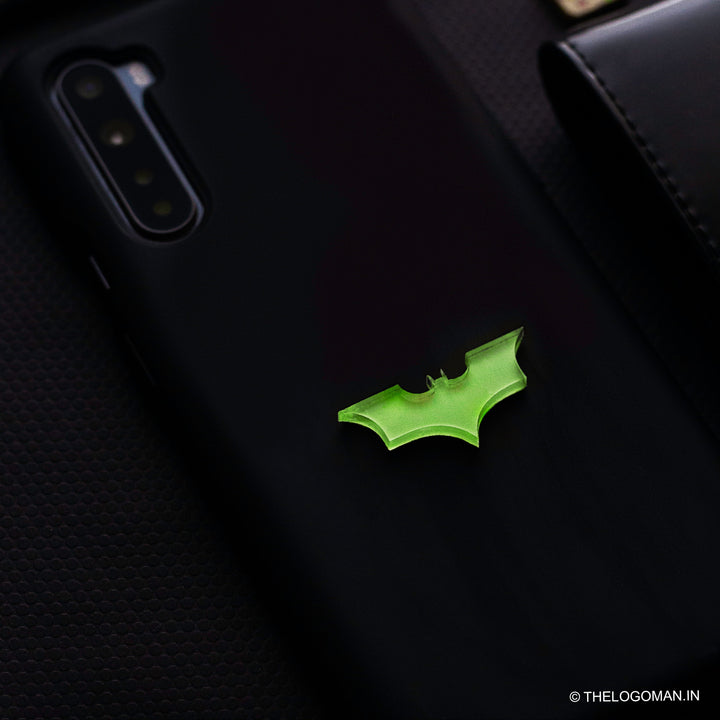 Black phone case with a green bat symbol on a dark background