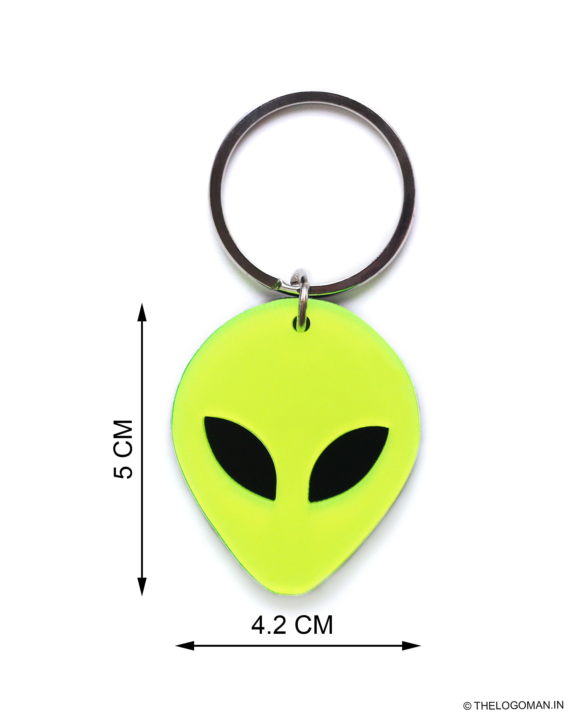 Green alien-shaped keychain with measurements on a white background