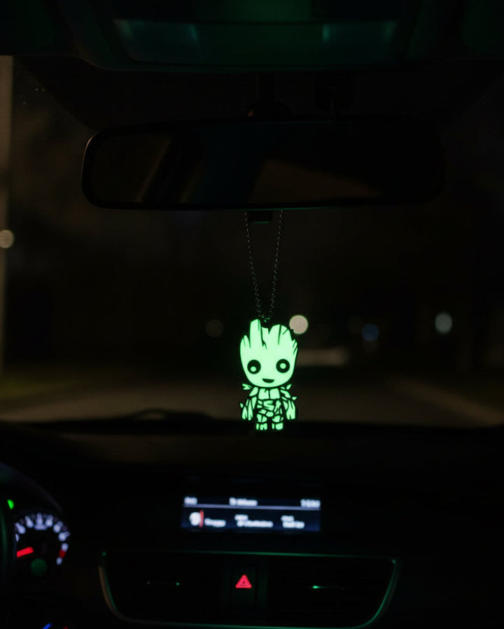 Glowing green character pendant on a chain against a white background