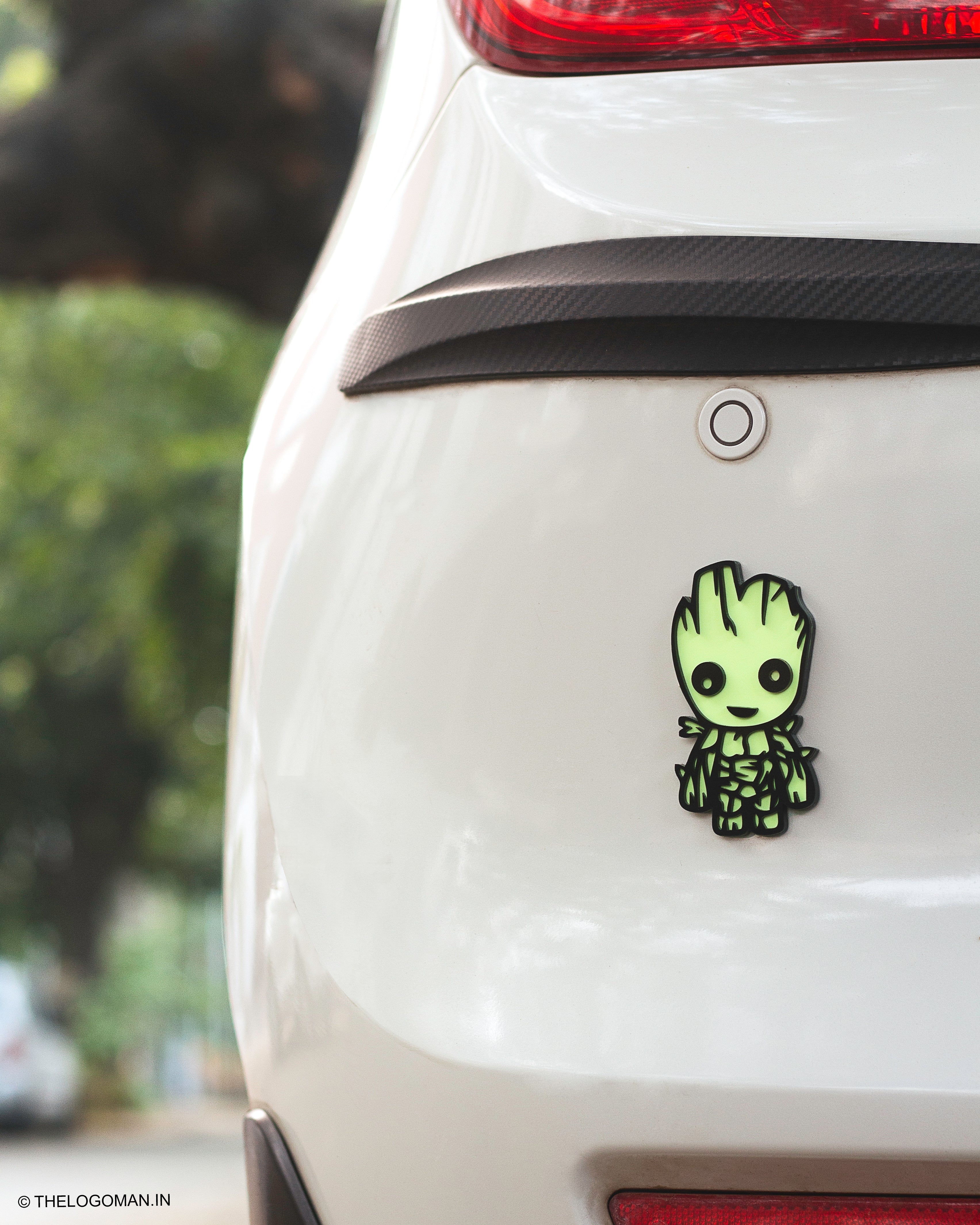 Car with a cute green character sticker on the back