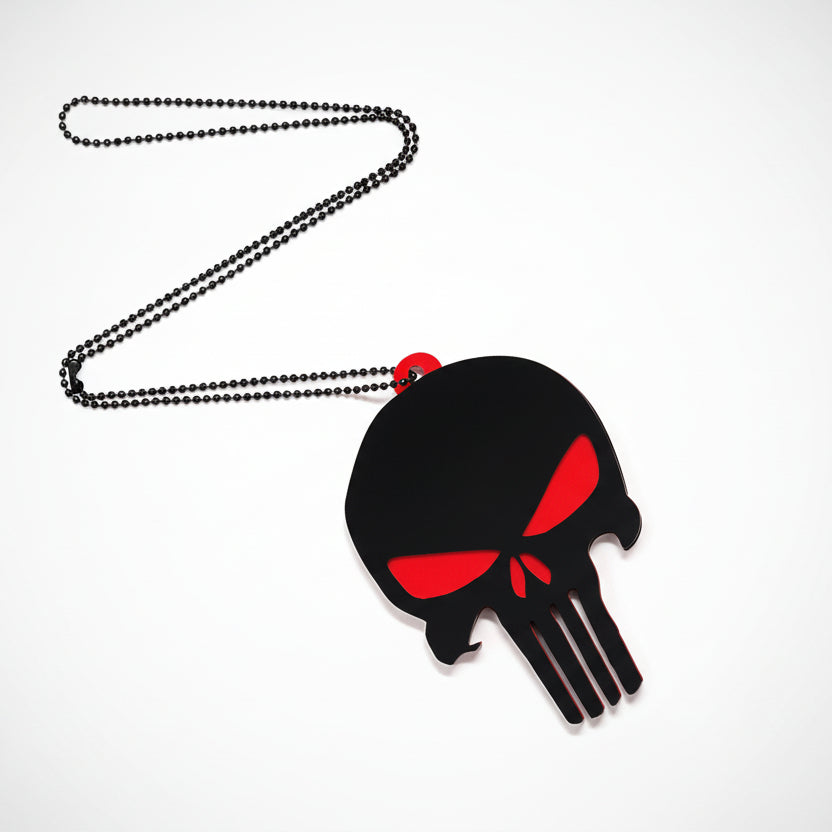 Black and red skull pendant on a chain against a white background