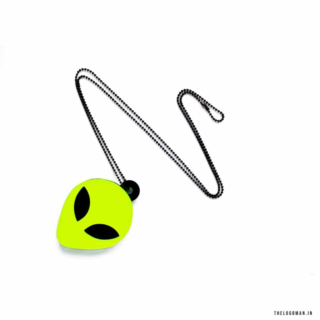 Neon green alien head charm with a black chain on a white background