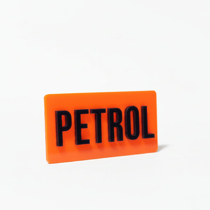Orange sign with 'PETROL' text on a white background