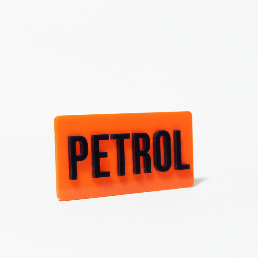 Orange sign with 'PETROL' text on a white background