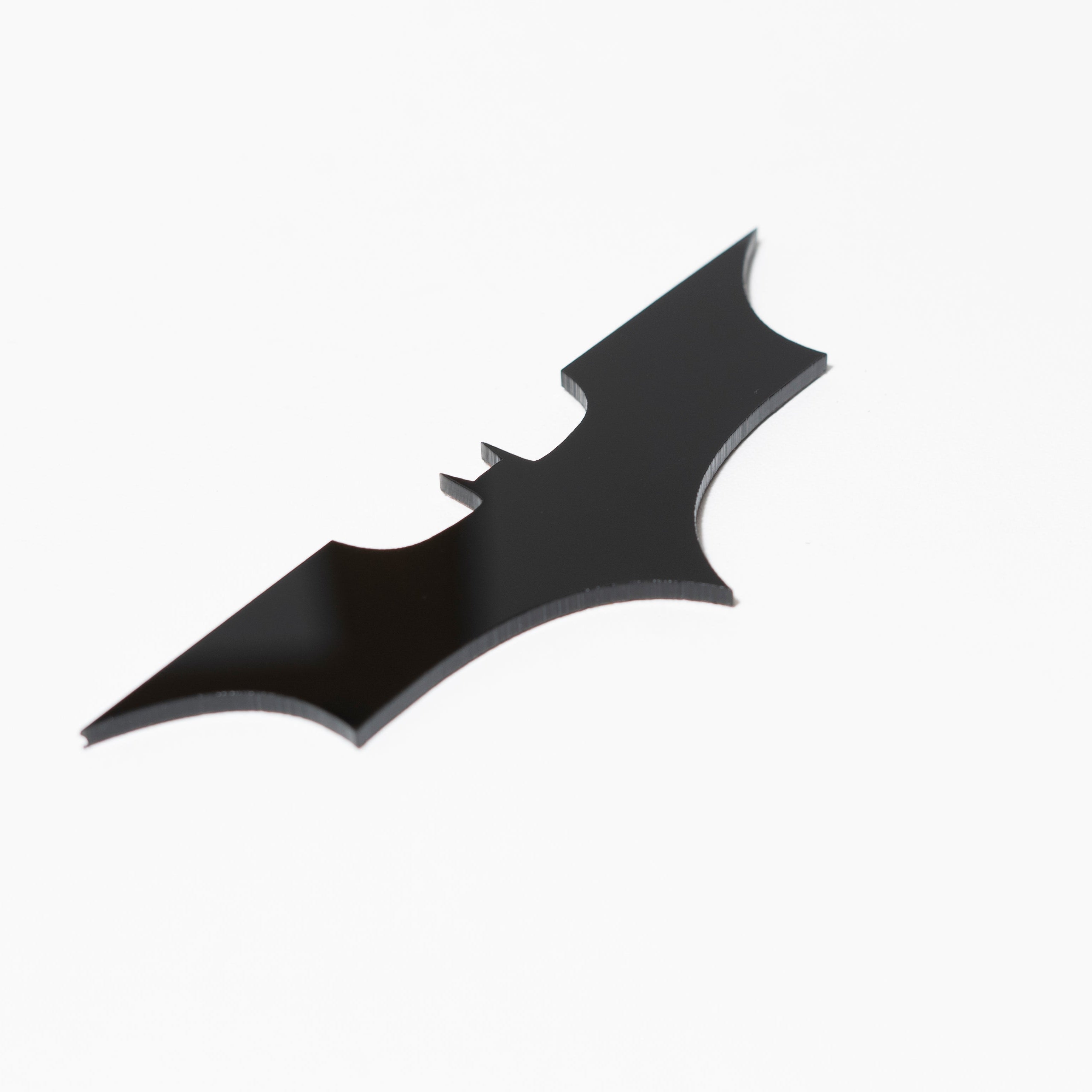 Black bat-shaped logo on a white background